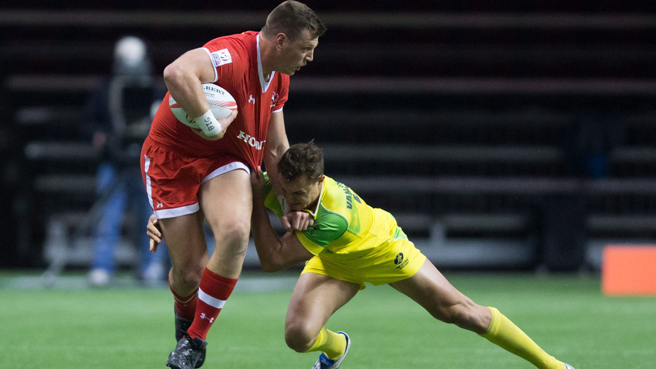 Adam Zaruba gets away from Australia's Stephan van der Walt during World Rugby Sevens Series' Canada Sevens tournament debut in Vancouver on March 12, 2016.