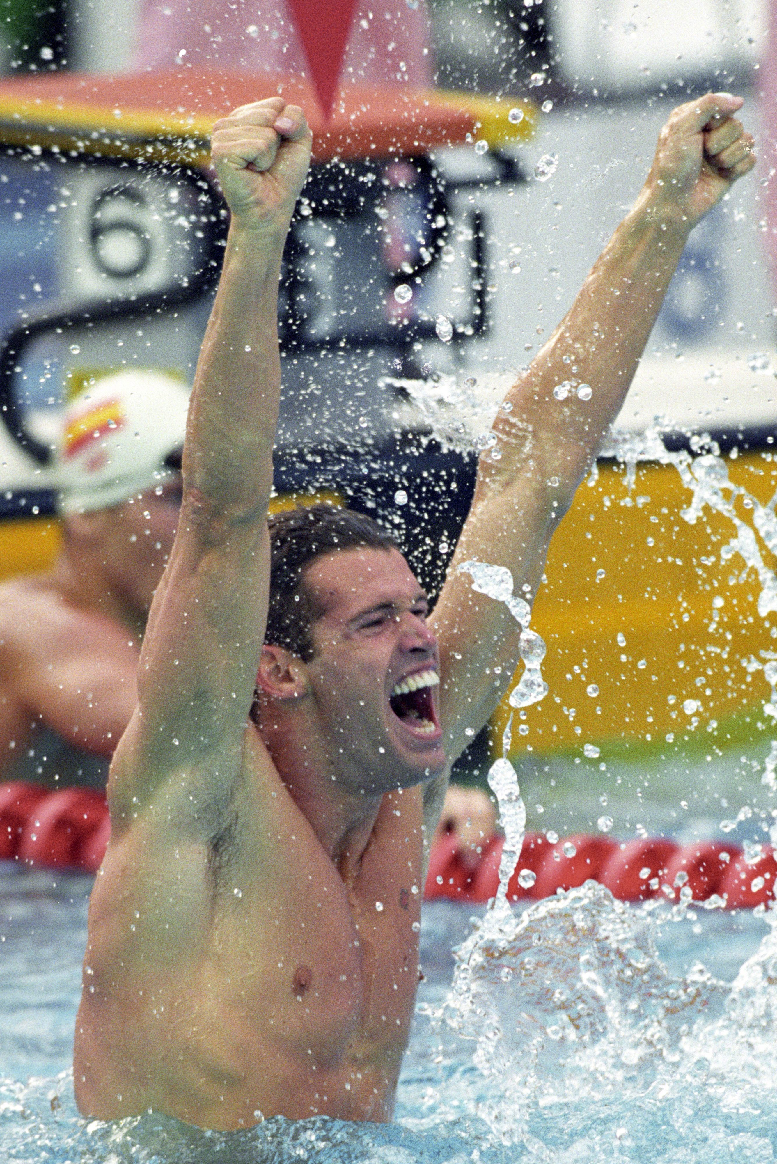 Swimmer sitting on lane rope cheering