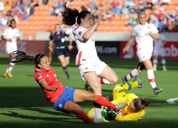 Canada goalkeeper Erin McLeod, right, grabs the ball as Allysha Chapman (2) avoids her as Costa Rica's Melissa Herrera (7) slides during the first half of a CONCACAF Olympic women's soccer qualifying championship semifinal Friday, Feb. 19, 2016, in Houston. (AP Photo/David J. Phillip)