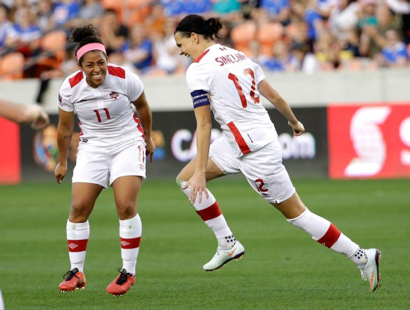 Canada's Christine Sinclair (12) celebrates after scoring a goal with Desiree Scott (11) against Costa Rica during the second half of a CONCACAF Olympic women's soccer qualifying championship semifinal Friday, Feb. 19, 2016, in Houston. Canada won 3-1. (AP Photo/David J. Phillip)