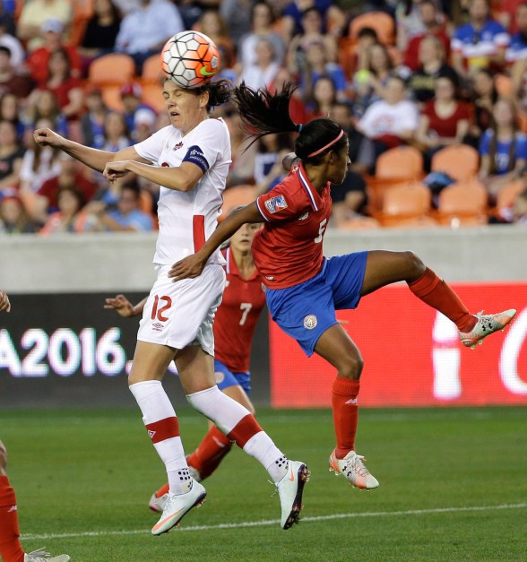 Canada's Christine Sinclair (12) heads the ball as Costa RicaÔø?s Diana Saenz (5) defends during the second half of a CONCACAF Olympic women's soccer qualifying championship semifinal Friday, Feb. 19, 2016, in Houston. Canada won 3-1. (AP Photo/David J. Phillip)