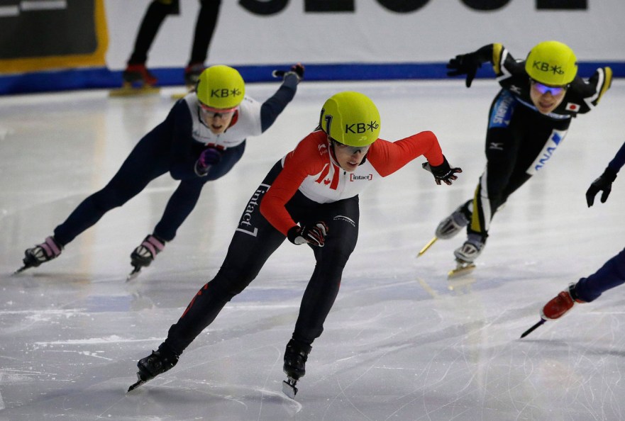 Marianne St-Gelais, center, of Canada competes against Elise Christie of Britain and Yui Sakai, right, of Japan during the women's 1500 meter final race at the ISU World Cup Short Track Speed Skating competition