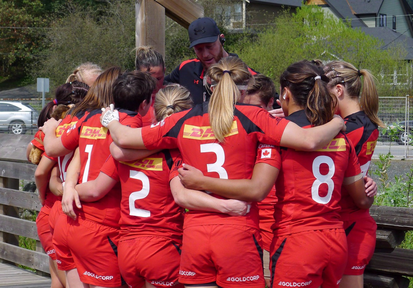 Coach John Tait speaks during a team huddle in Langford, BC (Photo: THE CANADIAN PRESS/Neil Davidson).