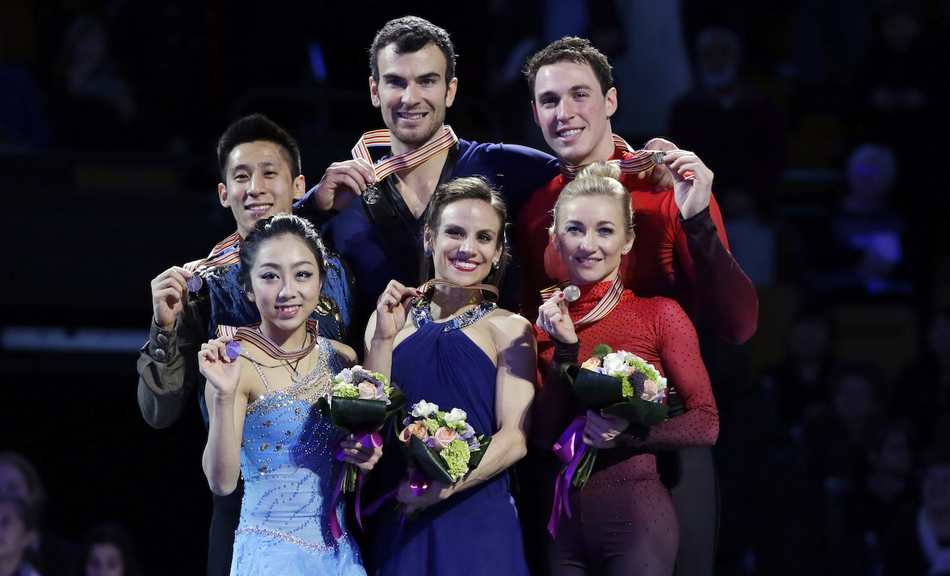 Silver medalists Wenjing Sui and Cong Han, left, of China, gold medalists Meagan Duhamel and Eric Radford, center, of Canada, and bronze medalists Aliona Savchenko and Bruno Massot, right, of Germany, pose with their medals during the awards ceremony for the pairs in the World Figure Skating Championships, Saturday, April 2, 2016, in Boston. (AP Photo/Elise Amendola)