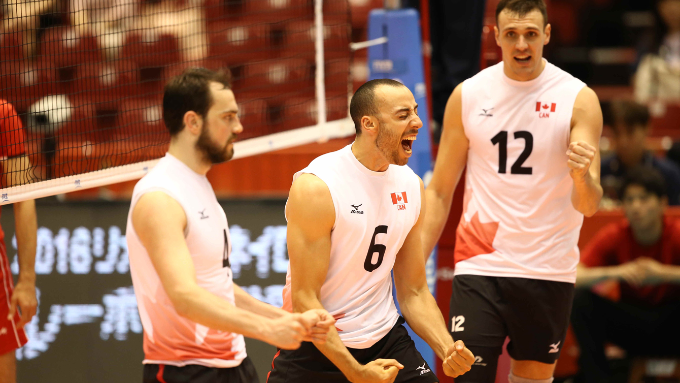 Canada's Justin Duff (centre) and Gavin Schmitt (right) celebrate at the World Olympic Qualifying Tournament on May 29 in Tokyo. (Photo via FIVB)