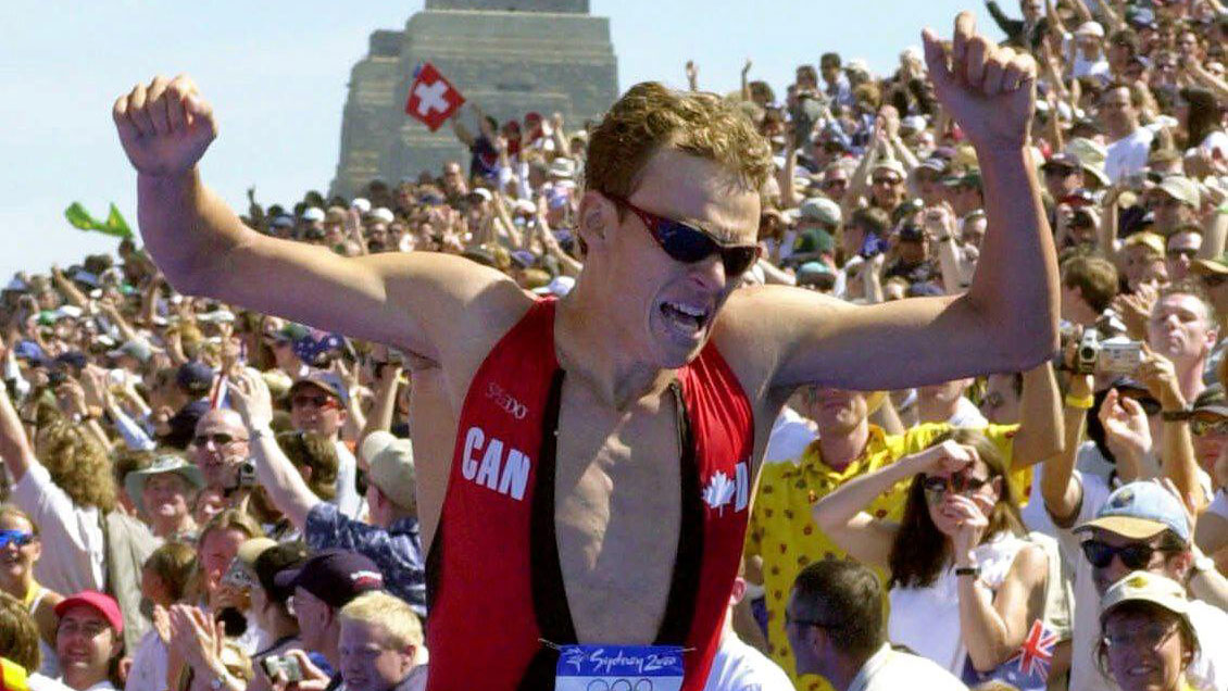 Simon Whitfield as he crosses the finish line at the Sydney 2000 triathlon in gold medal position on September 17, 2000. 