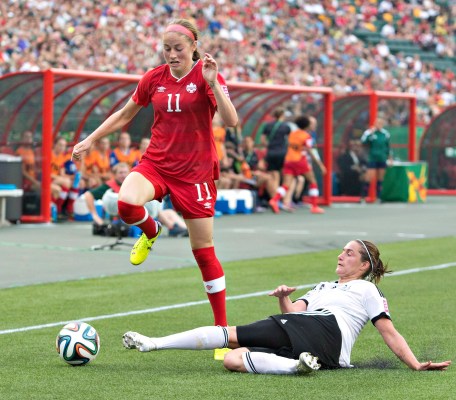 Canada's Janine Beckie (11) and Germany's Wibke Meister (15) battle for the ball during second half action of the FIFA U-20 Women's World Cup quarter-finals in Edmonton, Alta., on Saturday August 16, 2014. THE CANADIAN PRESS/Jason Franson