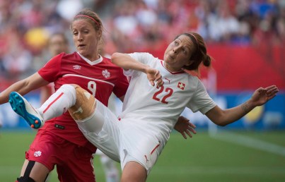 Switzerland's Vanessa Bernauer, right, fights for control of the ball with Canada's Josee Belanger during the second half of FIFA Women's World Cup round of 16 soccer action in Vancouver, B.C. Sunday, June 21, 2015. THE CANADIAN PRESS/Jonathan Hayward