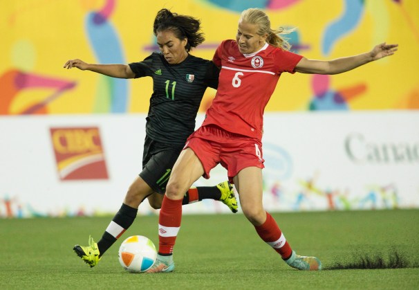 Canada's Rebecca Quinn (6) and Mexico's Monica Ocampo (11) fight for ball posession during the first half of the 2015 Pan Am Games women's bronze medal soccer match in Hamilton, Ontario on Friday, July 24, 2015. THE CANADIAN PRESS/Peter Power
