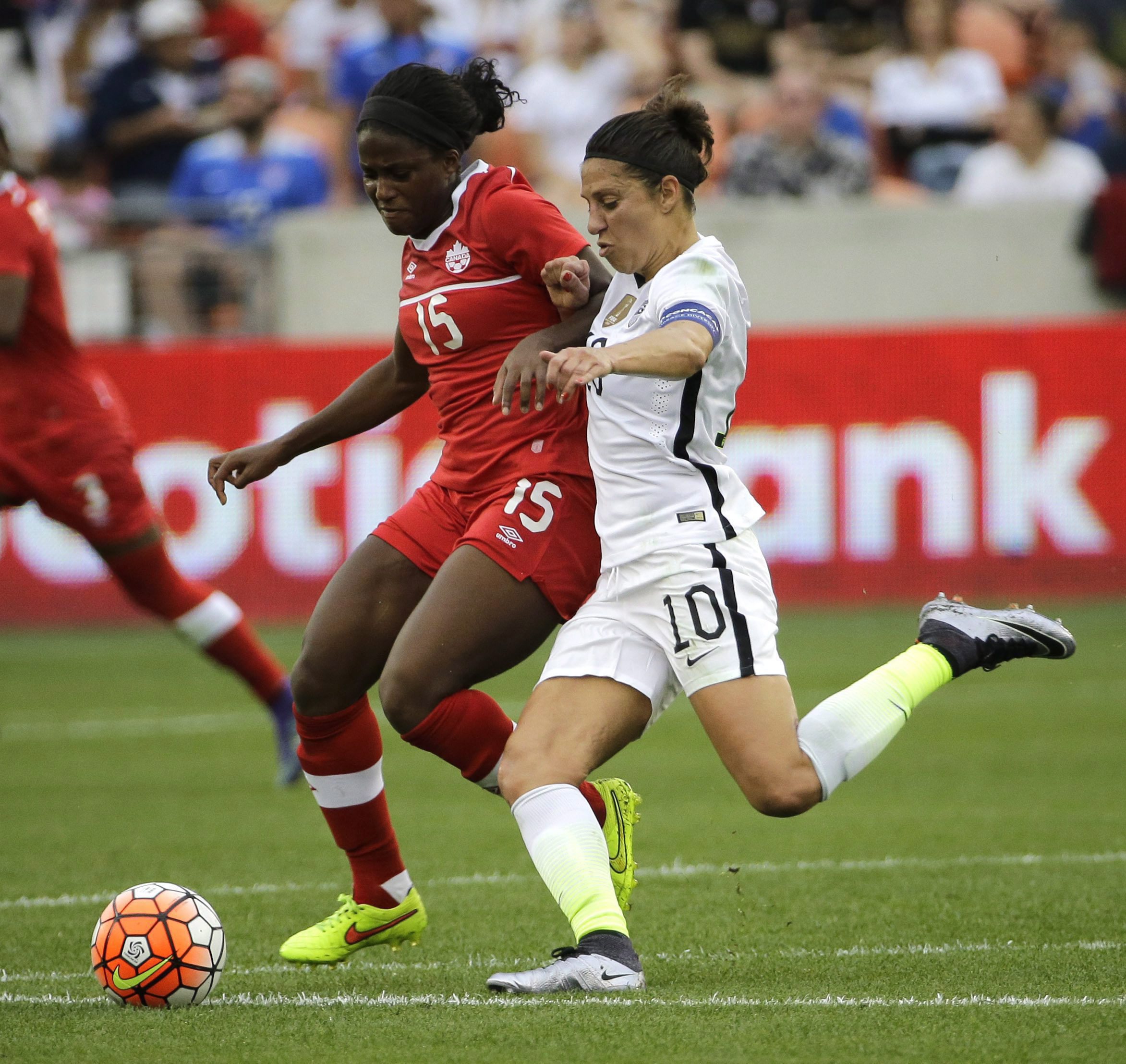United States Carli Lloyd (10) challenges Canada's Nichelle Prince (15) for the ball during the first half of the CONCACAF Olympic women's soccer qualifying championship final Sunday, Feb. 21, 2016, in Houston. (AP Photo/David J. Phillip)