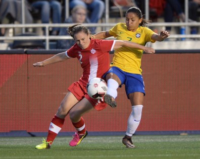 Canada's Allysha Chapman (2) fights for the ball against Brazil's Debinha during second half international women's soccer friendly action in Ottawa on Tuesday, June 7, 2016. THE CANADIAN PRESS/Sean Kilpatrick