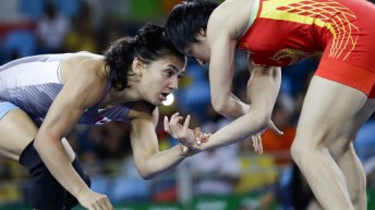 Canada's Jasmine Mian, blue, competes against China's Sun Yanan