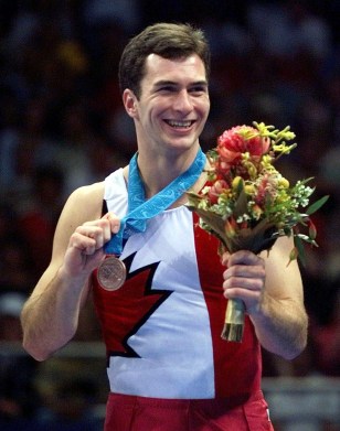 Mathieu Turgeon of Toronto smiles after winning the bronze medal in the first ever men's trampoline competition at the Summer Olympics in Sydney on Saturday, Sept. 23, 2000. (AP Photo/Amy Sancetta)
