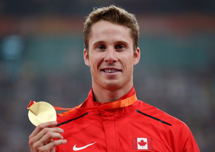 High jumper Derek Drouin holds up his gold medal at the IAAF World Championships