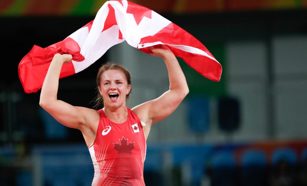 Erica Wiebe flying the Canadian flag after winning gold in Rio
