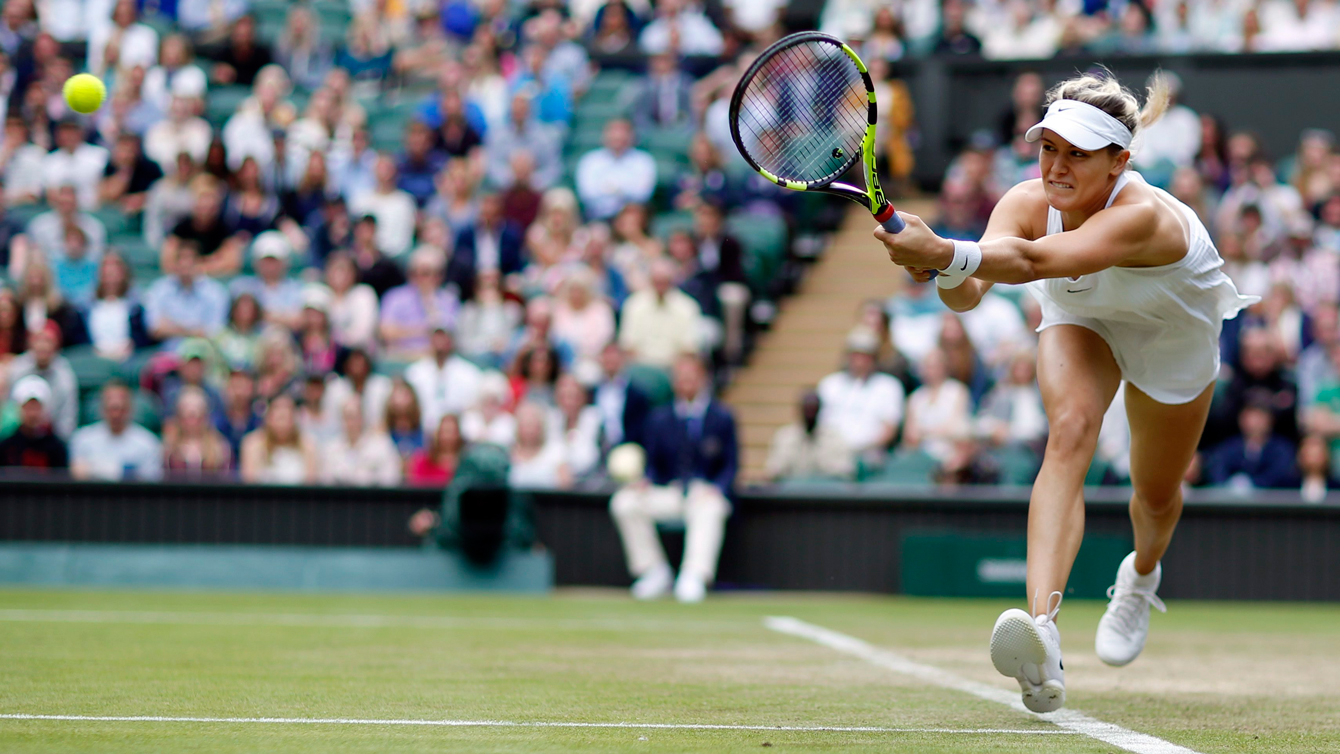 Eugenie Bouchard of Canada returns to Johanna Konta of Britain during their women's singles match on day four of the Wimbledon Tennis Championships in London, Thursday, June 30, 2016. (AP Photo/Alastair Grant)