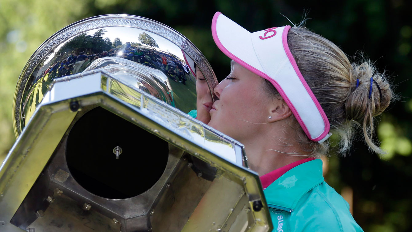 Brooke Henderson kisses the Women's PGA Championship trophy after winning her first major on June 12, 2016. 