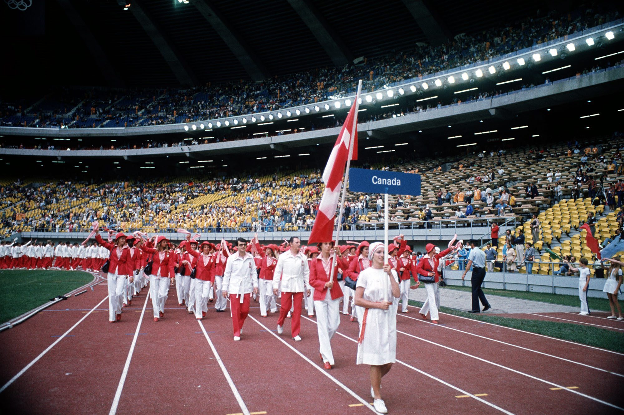 Abby Hoffman carries the Canadian Flag as she leads her team into the Olympic stadium in Montreal July 17, 1976 during the opening ceremonies for the games. Hoffman, 29, from Toronto, will compete in the 800 meter run. (CP PHOTO/ file)