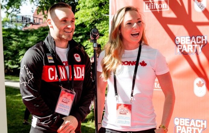 Gymnasts Rosie MacLennan and Scott Morgan laugh during interviews at Beach Party.