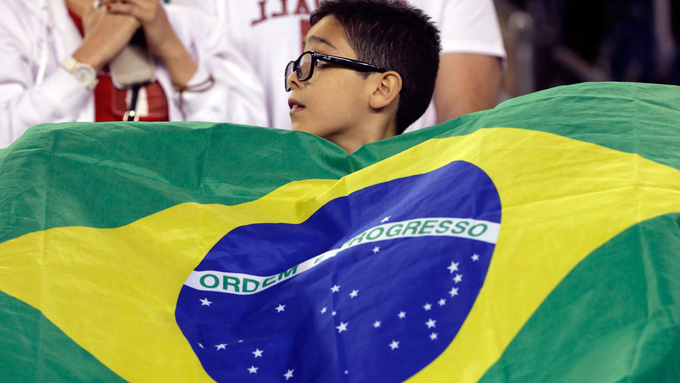 A young Brazil supporter waves his country's flag before a Copa America Group B soccer match between Brazil and Peru on Sunday, June 12, 2016, in Foxborough, Mass. (AP Photo/Steven Senne)
