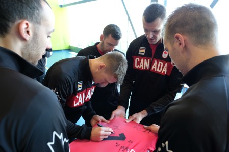 The Canadian Men's Volleyball team signing a jersey on July 22, 2016. (Thomas Skrlj/COC)