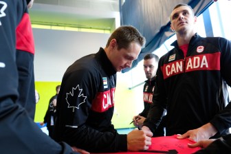 The Canadian Men's Volleyball team signing a jersey on July 22, 2016. (Thomas Skrlj/COC)