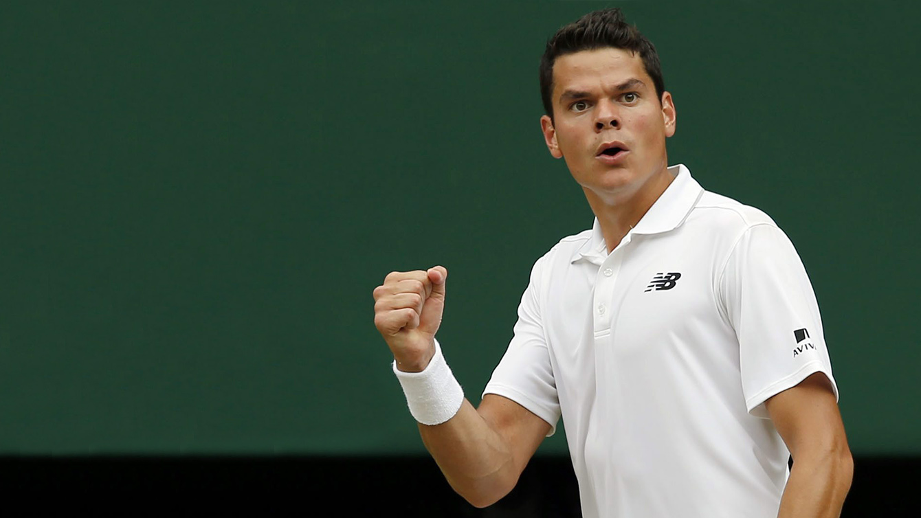 Milos Raonic of Canada celebrates a point against Roger Federer of Switzerland during their men's semifinal singles match on day twelve of the Wimbledon Tennis Championships in London, Friday, July 8, 2016. (AP Photo/Alastair Grant)