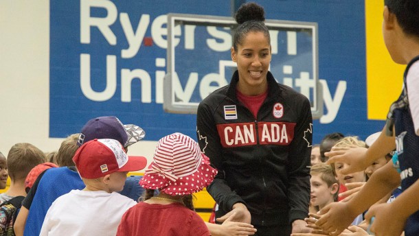 Miranda Ayim runs through a crowd of children before heading onto the stage for the Team Canada basketball announcement on July 22, 2016. (Tavia Bakowski/COC)