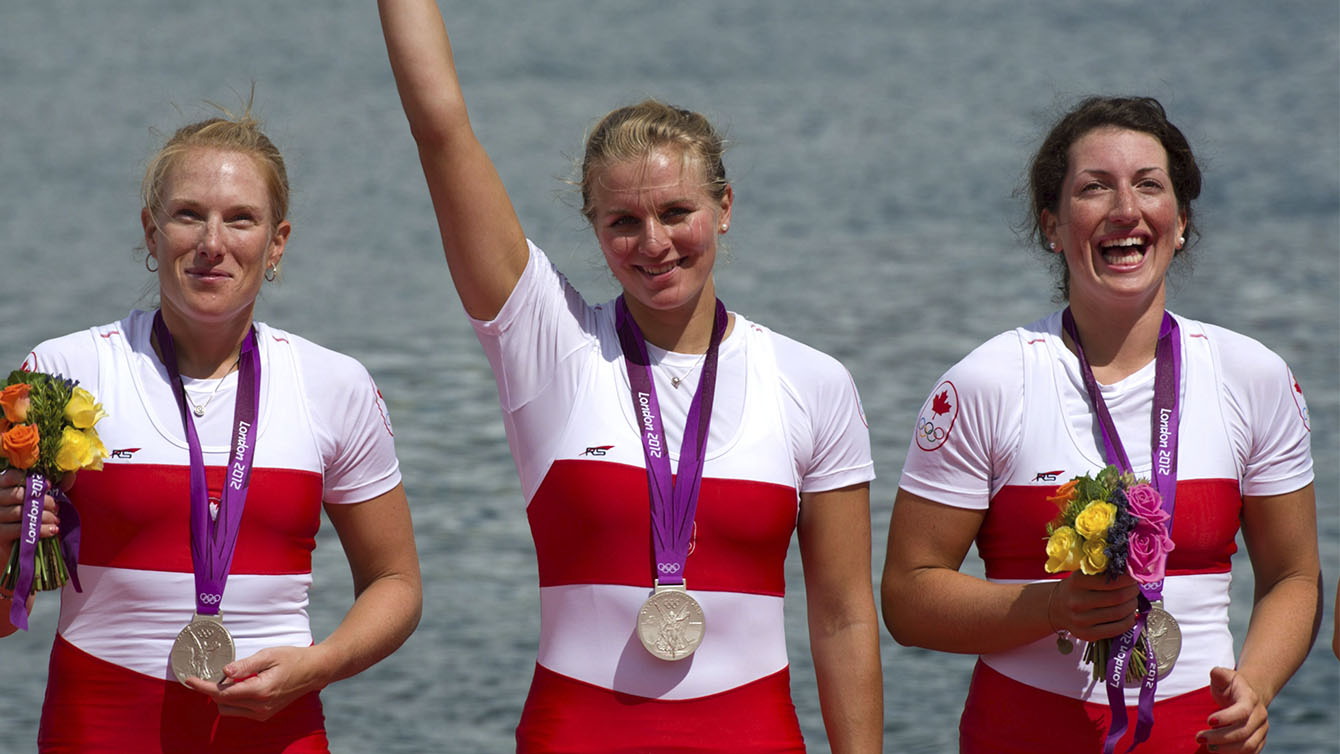 Canada's women's eight rowing team members Krista Guloien, Lauren Wilkinson, Natalie Mastracc celebrate their silver medal finish at Eton Dorney during the 2012 Summer Olympics in Dorney, England on Thursday, August 2, 2012. THE CANADIAN PRESS/Sean Kilpatrick