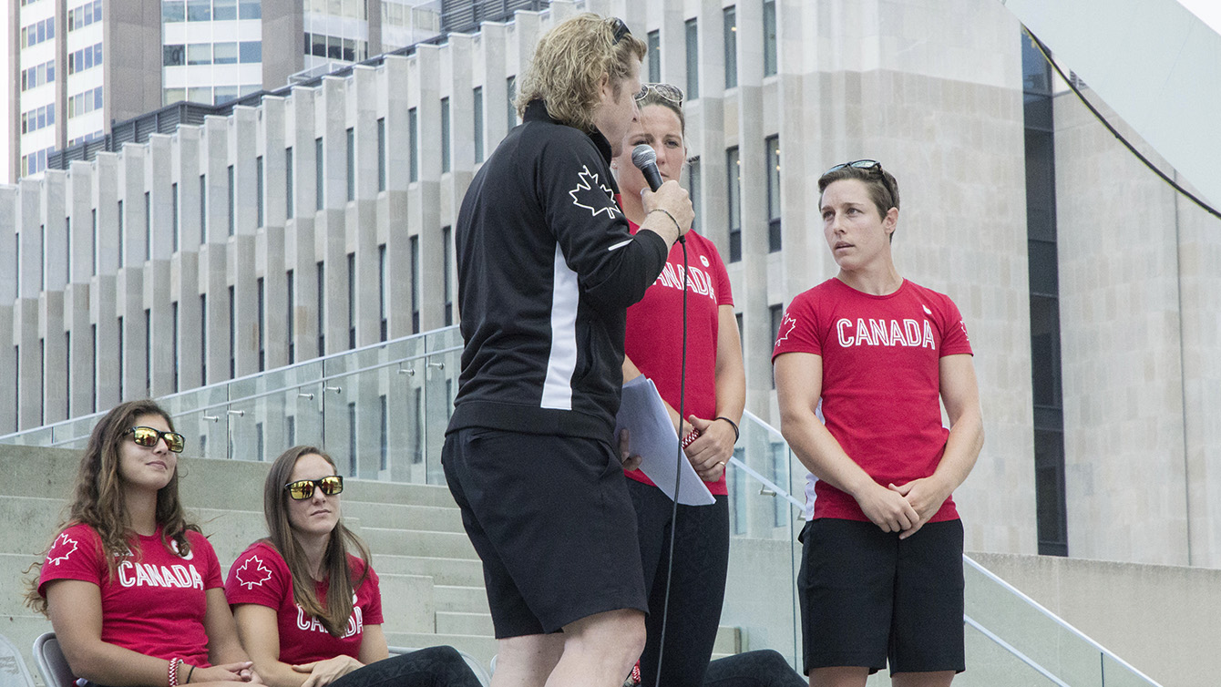 Ghislaine Landry speaks to Curt Harnett, Chef de Mission for Team Canada during Rio 2016 at the rugby send-off party on July 26, 2016. (Tavia Bakowski/COC)