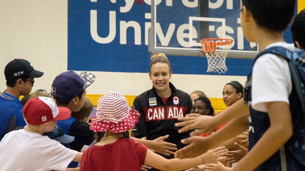 Shona Thorburn runs through a crowd of children before heading onto the stage for the Team Canada basketball announcement on July 22, 2016. (Tavia Bakowski/COC)