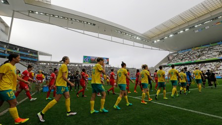 Australia, front row, and Canada team soccer players enter the field before their 2016 Summer Olympics football match at the Arena Corinthians in Sao Paulo, Brazil, Wednesday, Aug. 3, 2016. (AP Photo/Nelson Antoine)
