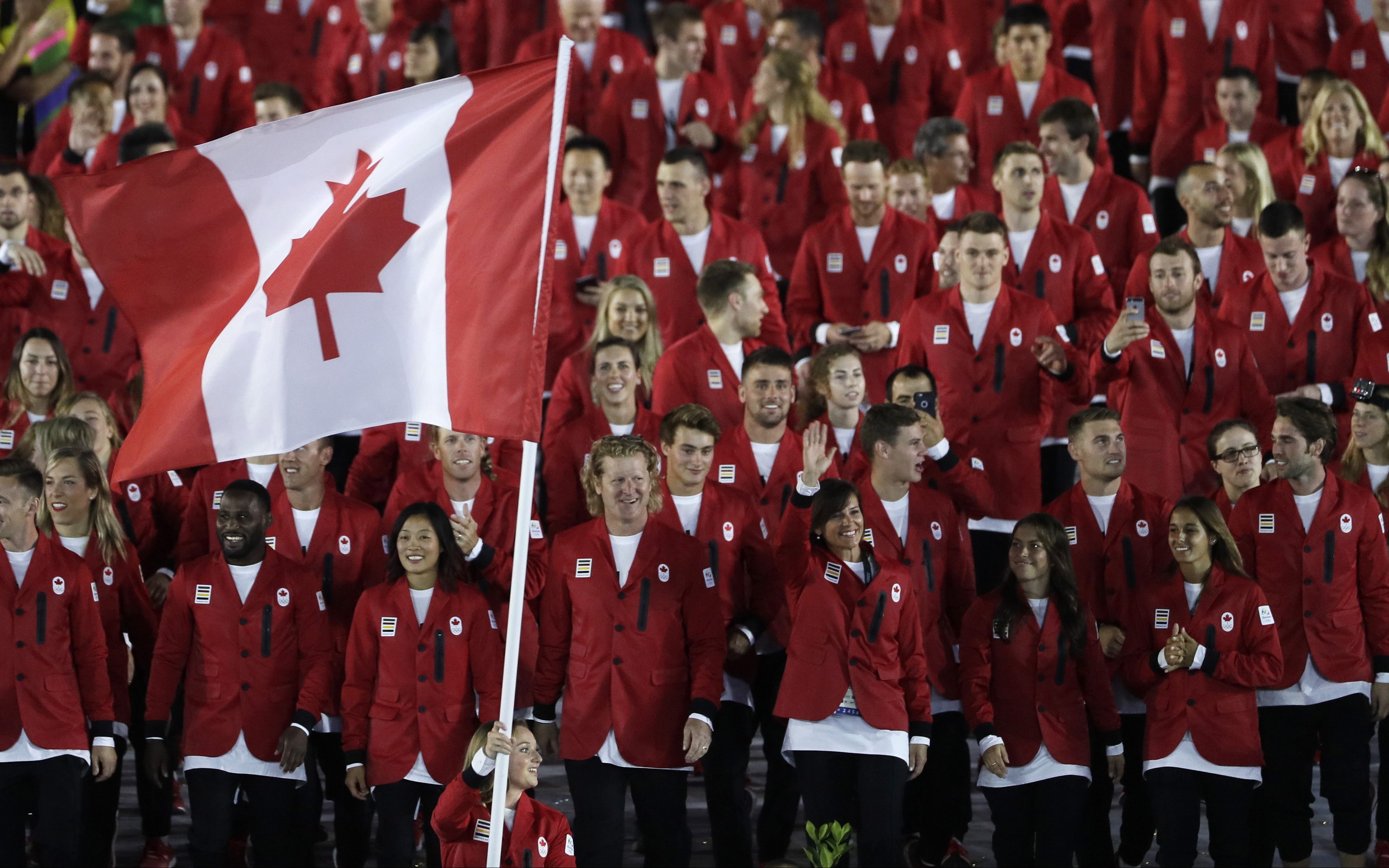 Rosannagh Maclennan carries the flag of Canada during the opening ceremony for the 2016 Summer Olympics in Rio de Janeiro, Brazil, Friday, Aug. 5, 2016. (AP Photo/Matt Slocum)