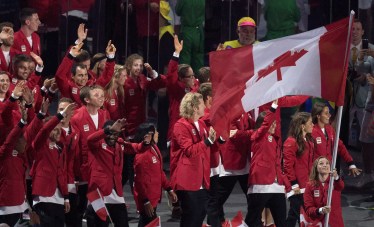 Rosie MacLennan carries the flag as she leads Canada into the opening ceremonies for the 2016 Summer Olympics Friday August 5, 2016 in Rio de Janeiro, Brazil. THE CANADIAN PRESS/Frank Gunn