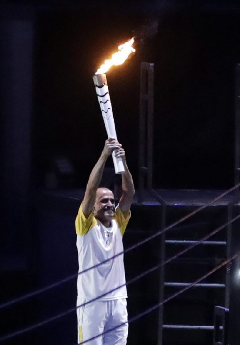 Brazilian marathon runner Vanderlei de Lima holds up the Olympic flame during the opening ceremony for the 2016 Summer Olympics AP/Michael Sohn