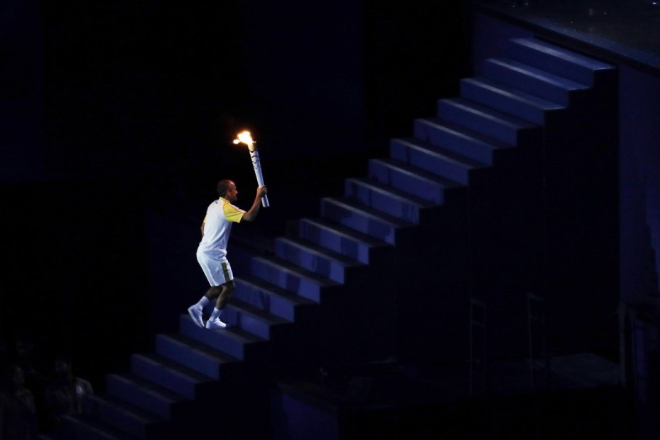 Vanderlei de Lima climbs a stair before lighting the Olympic cauldron during the opening ceremony for the 2016 Summer Olympics in Rio de Janeiro, Brazil, Friday, Aug. 5, 2016. (AP Photo/Dmitri Lovetsky)