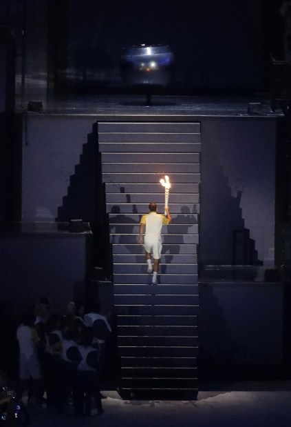Brazilian marathoner Vanderlei de Lima lights the Olympic flame during the opening ceremony for the 2016 Summer Olympics in Rio de Janeiro, Brazil, Friday, Aug. 5, 2016. (AP Photo/Matthias Schrader)