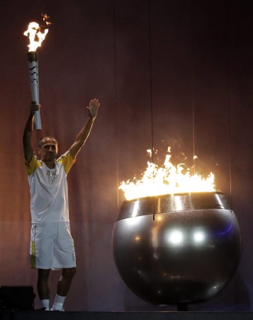 Brazilian marathon runner Vanderlei de Lima lights the Olympic cauldron during the opening ceremony for the 2016 Summer Olympics in Rio de Janeiro, Brazil, Friday, Aug. 5, 2016. (AP Photo/Matt Dunham)