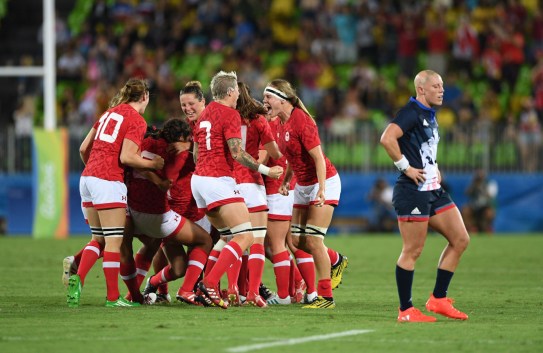 Canada's captain Jen Kish (7) screams in joy with teammate Karen Paquin, middle right, as Great Britain's Heather Fisher walks off the field during the bronze medal match in women's rugby sevens at the 2016 Olympic Summer Games in Rio de Janeiro, Brazil on Monday, Aug. 8, 2016. Canada defeated Britain to be come the first medal winner in Olympic womens rugby sevens. THE CANADIAN PRESS/Sean Kilpatrick