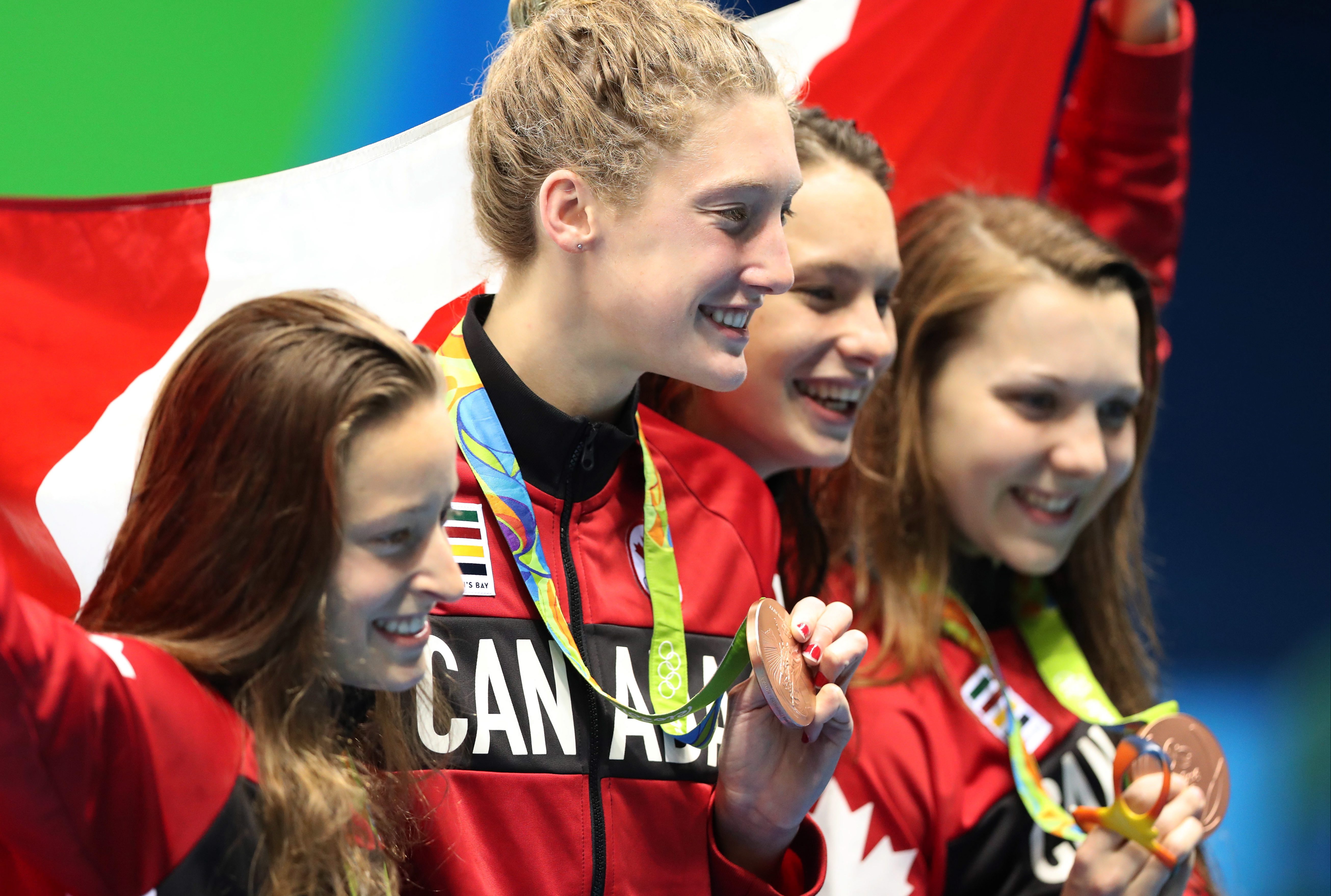 The Canada team hold up their bronze medals after winning the women's 4x200-meter freestyle relay during the swimming competitions at the 2016 Summer Olympics, Thursday, Aug. 11, 2016, in Rio de Janeiro, Brazil. (AP Photo/Lee Jin-man)