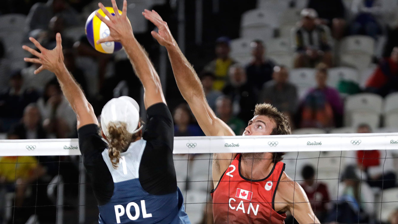 Ben Saxton attacks Poland in the lucky loser match at the Rio 2016 beach volleyball tournament, Thursday, Aug. 11, 2016. (AP Photo/Petr David Josek)