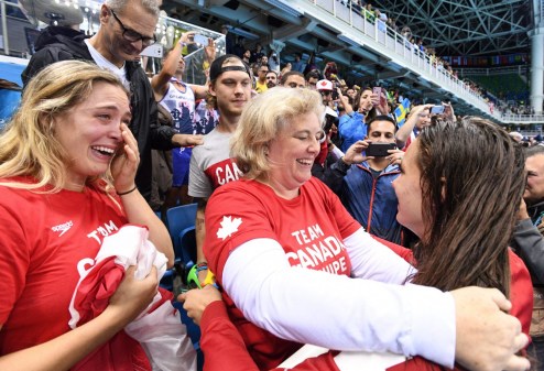 OLY SWM Canada 20160811 Canada's Penny Oleksiak, right, gets a hug from her mom following her gold-medal performance at the women's 100m freestyle finals during the 2016 Olympic Summer Games in Rio de Janeiro, Brazil, on Friday, Aug. 12, 2016. THE CANADIAN PRESS/Sean Kilpatrick