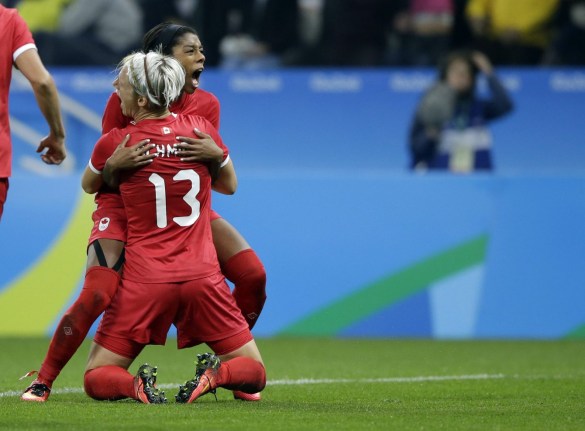 Canada's Sophie Schmidt, celebrates with teammate Canada's Ashley Lawrence celebrates after scoring her team's first goal during a quarter-final match of the women's Olympic football tournament between Canada and France in Sao Paulo, Brazil, Friday Aug. 12, 2016.(AP Photo/Nelson Antoine)