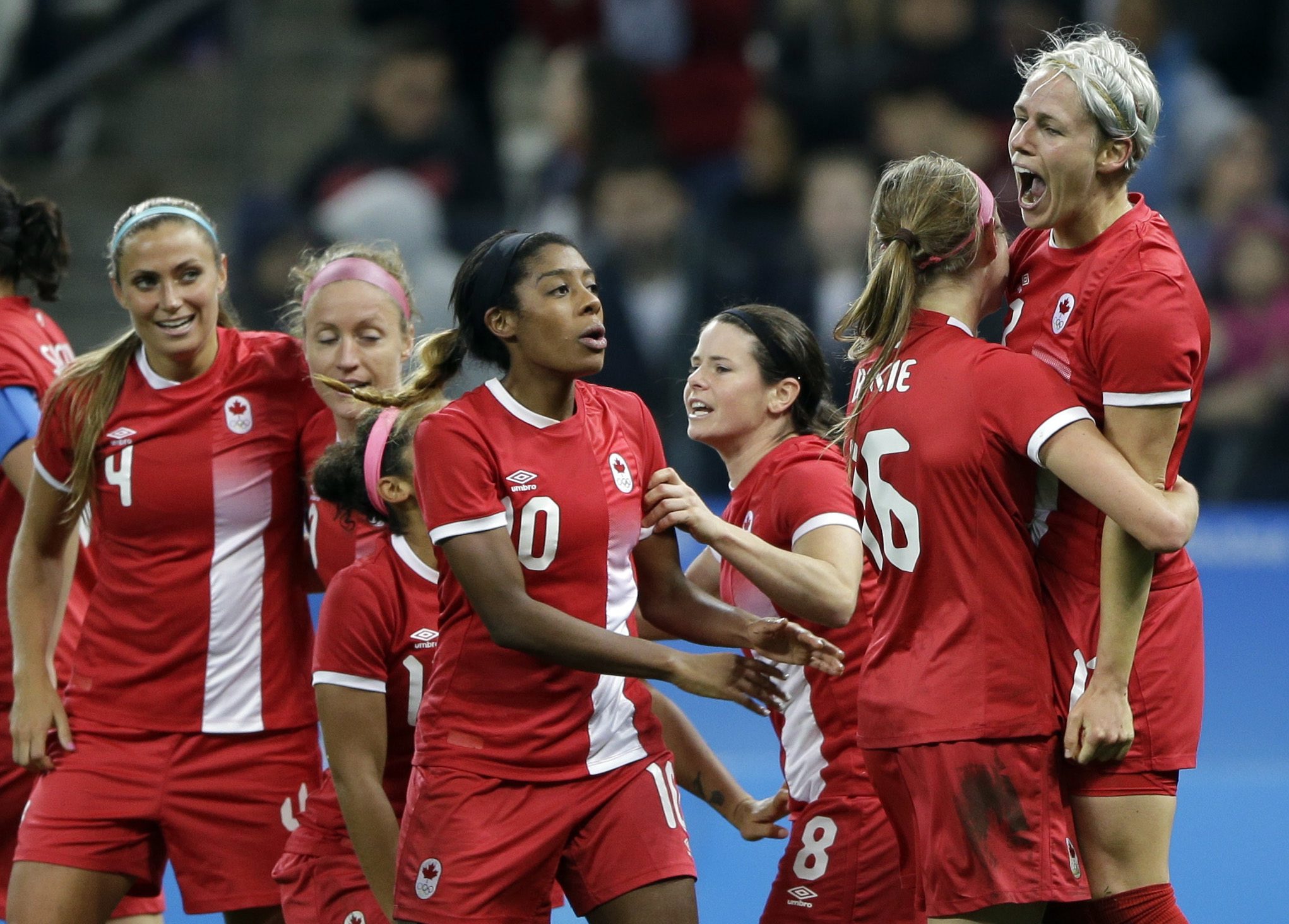 Canada's Sophie Schmidt, right, celebrates after scoring her team's first goal during a quarter-final match of the women's Olympic football tournament between Canada and France in Sao Paulo, Brazil, Friday Aug. 12, 2016.(AP Photo/Nelson Antoine)