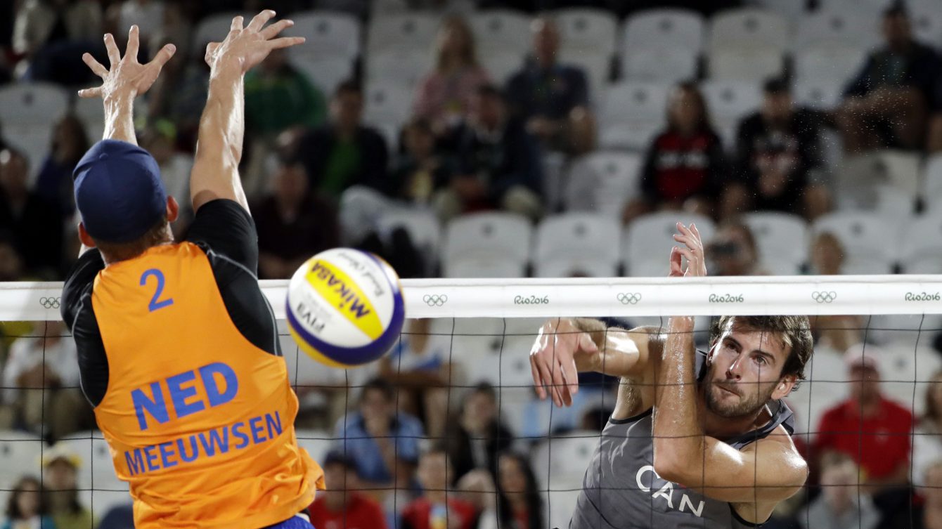 Ben Saxton spikes past Netherlands' Robert Meeuwsen during the round of 16 match at the 2016 Summer Olympics in Rio de Janeiro, Brazil, Saturday, Aug. 13, 2016. (AP Photo/Marcio Jose Sanchez)