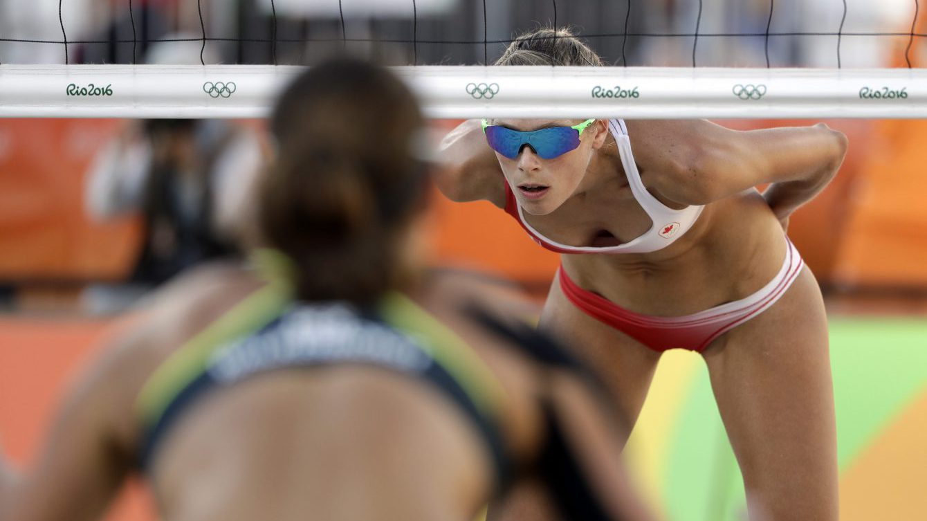 Canada's Sarah Pavan, right, awaits a serve against Germany during a women's beach volleyball quarterfinal match at the 2016 Summer Olympics in Rio de Janeiro, Brazil, Sunday, Aug. 14, 2016. (AP Photo/Marcio Jose Sanchez)