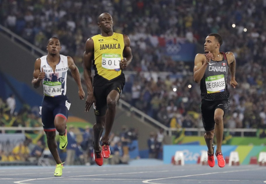 Jamaica's Usain Bolt, centre, Canada's Andre De Grasse, right, and Britain's Chijindu Ujah compete in a men's 100-meter semifinal during the athletics competitions of the 2016 Summer Olympics at the Olympic stadium in Rio de Janeiro, Brazil, Sunday, Aug. 14, 2016. (AP Photo/David J. Phillip)