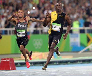 Jamaica's Usain Bolt celebrates as he crosses the line to win gold in the men's 100-meter final with Canada's Andre de Grasse during the athletics competitions of the 2016 Summer Olympics at the Olympic stadium in Rio de Janeiro, Brazil, Sunday, Aug. 14, 2016. (AP Photo/Lee Jin-man)