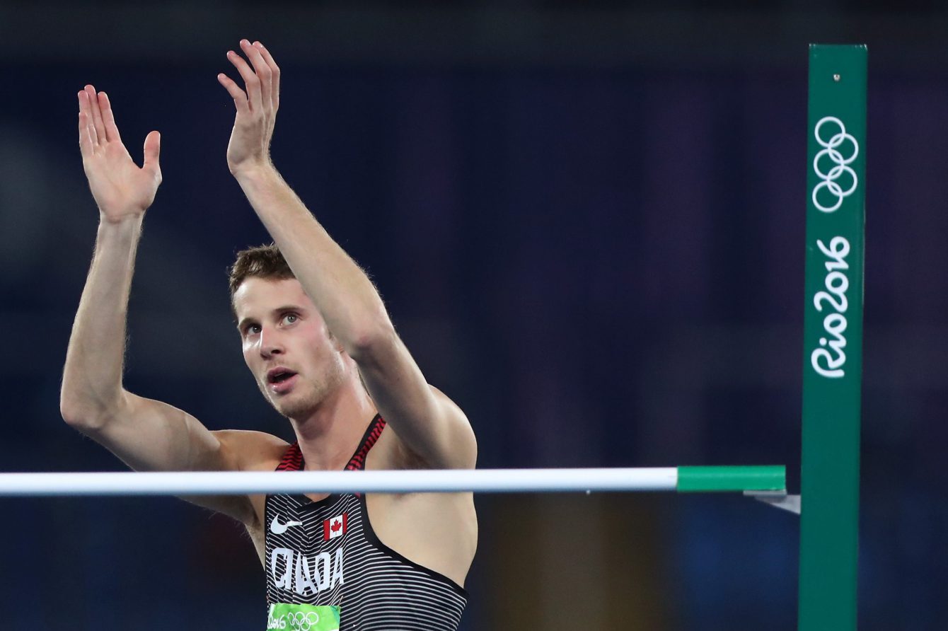 Canada's Derek Drouin applauds after an attempt in the men's high jump final during the athletics competitions of the 2016 Summer Olympics at the Olympic stadium in Rio de Janeiro, Brazil, Tuesday, Aug. 16, 2016. (AP Photo/Lee Jin-man)