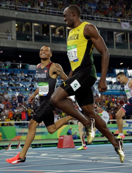 Canada's Andre De Grasse, left, and Jamaica's Usain Bolt smile to each other as they cross the line of a men's 200-meter semifinal during the athletics competitions of the 2016 Summer Olympics at the Olympic stadium in Rio de Janeiro, Brazil, Wednesday, Aug. 17, 2016. (AP Photo/Tim Donnelly)
